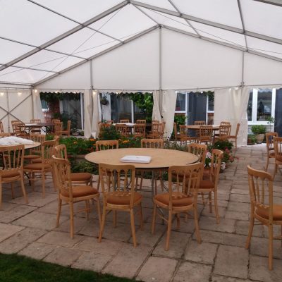 Marquee with tables and chairs set up on patio