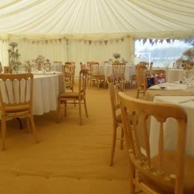 Wooden chairs inside of marquee